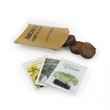 Étui berlingot en carton kraft avec texte imprimé, accompagné de tourbe et sachets de graines, marquage visible sur l’étui.